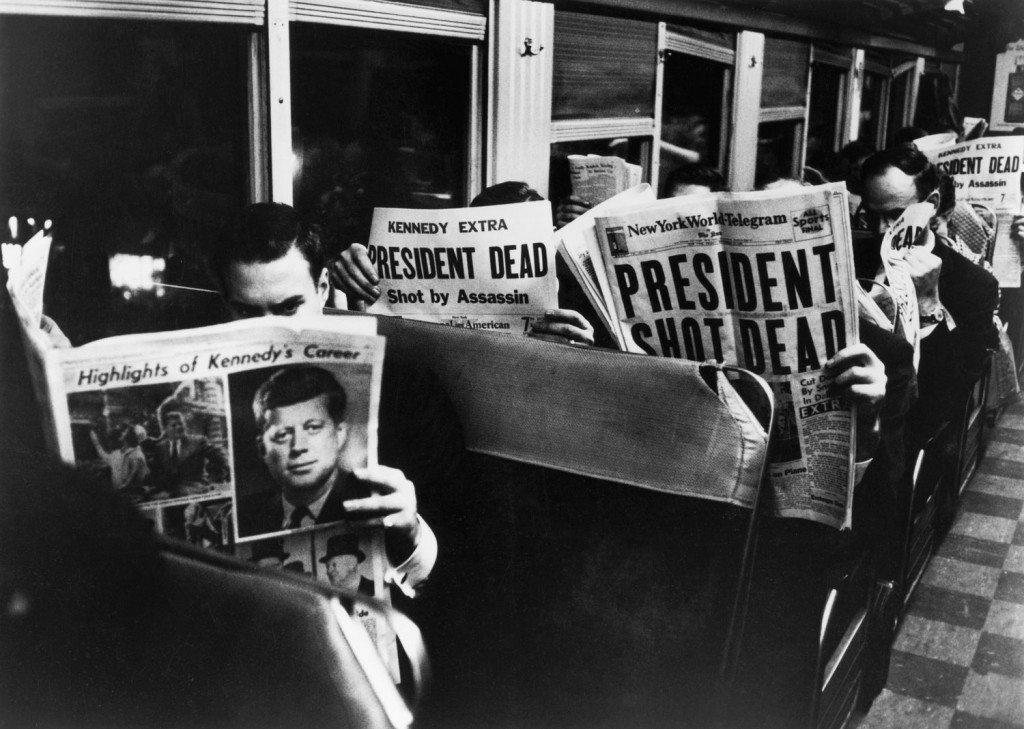 'PRESIDENT SHOT DEAD': New York subway transients and commuters reading the tragic news on their way home. The New York Journal-American and The New York World-Telegram. Late-Friday evening, November 22, 1963